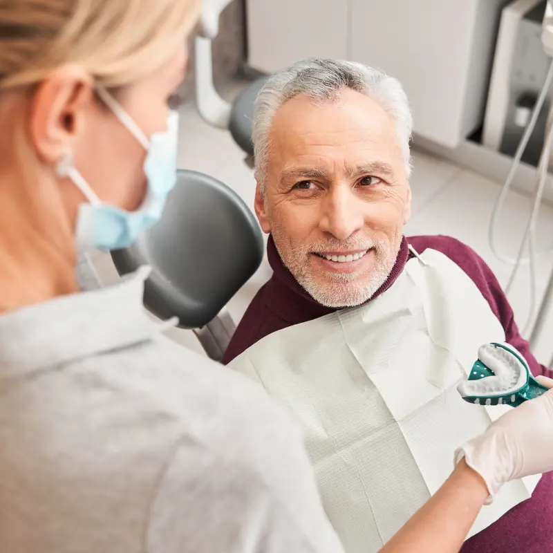 Older patient smiling during denture impression appointment at Walk in the Park Family Dental in Kitchener