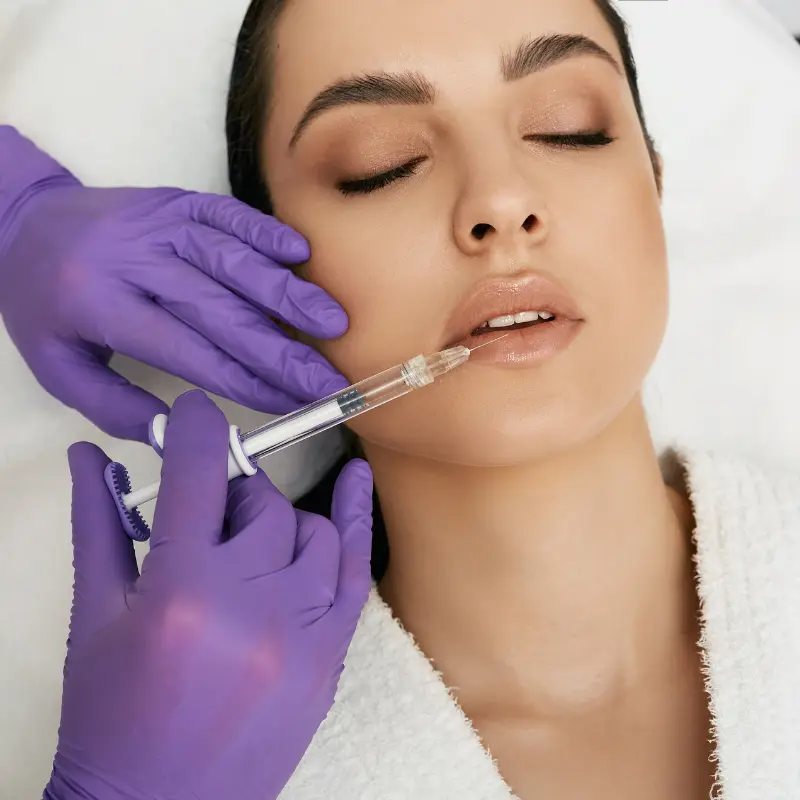 Clinician administering a lip filler injection to enhance lip volume at Walk in the Park Family Dental in Kitchener