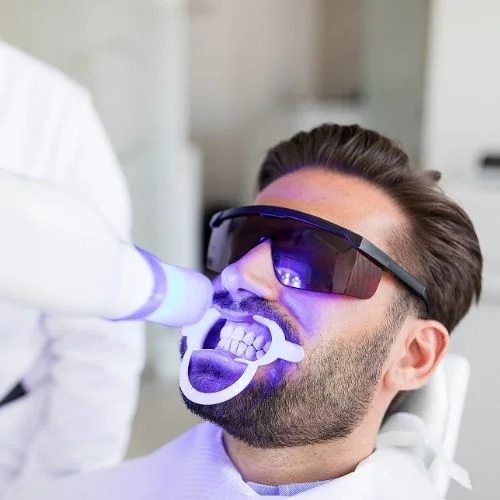 Patient receiving professional LED teeth whitening treatment at Walk in the Park Family Dental in Kitchener
